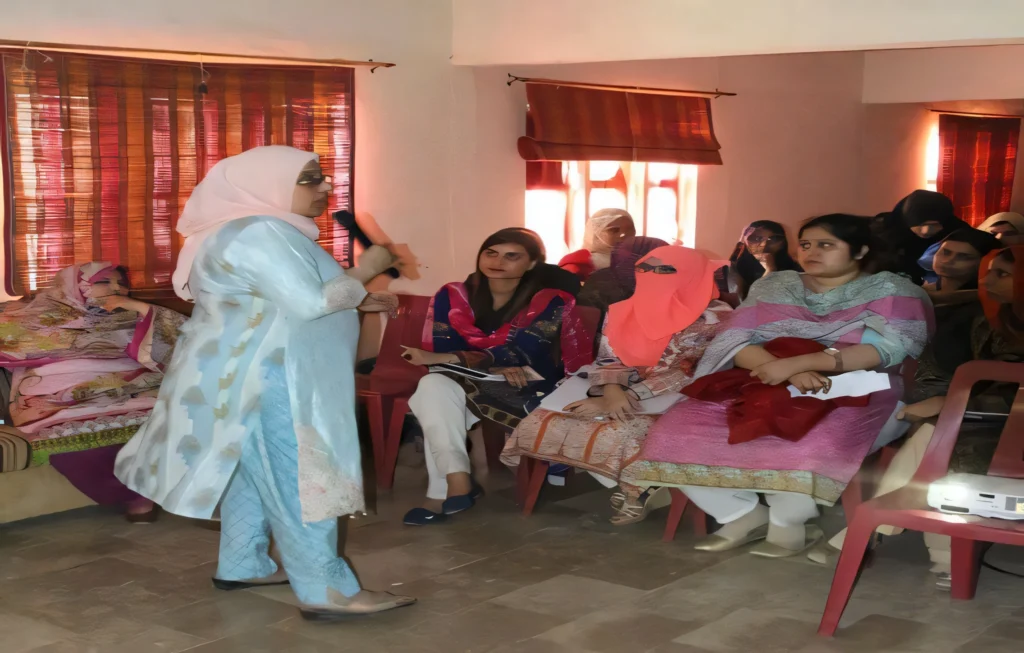 "Dr. Farida Sheikh, a holistic education expert, delivering a professional training session to female educators in a classroom, fostering inclusive learning environments."